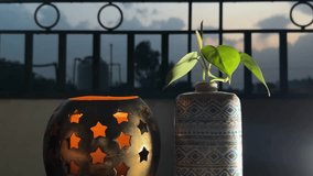 Green leaves plant pot with candlelight bowl during sunset time beautiful sky 