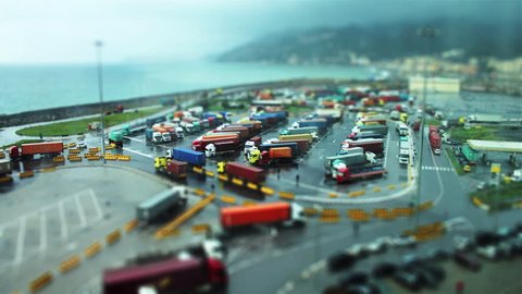Traffic of trucks for the transport of goods near the sea tilt shift time lapse