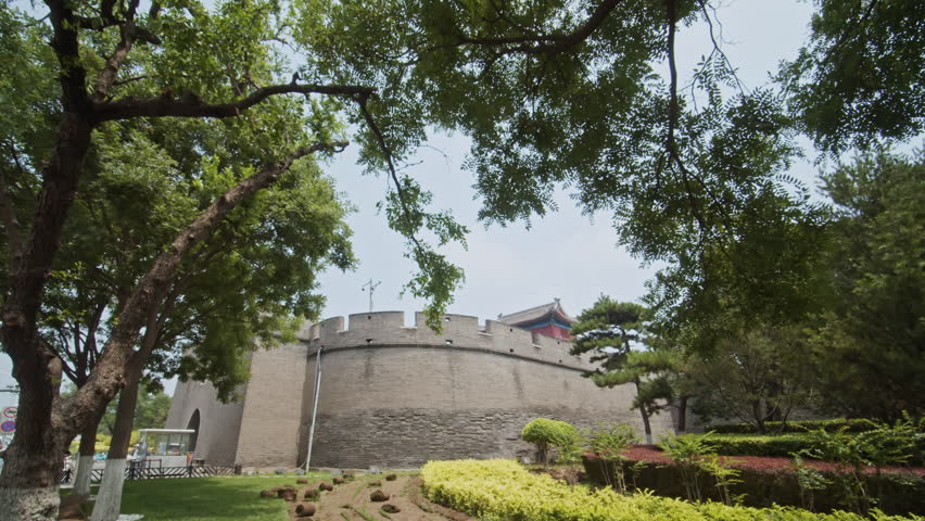Ancient Stone wall of Beijing surrounded by flowers