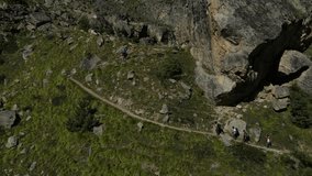 Aerial drone footage of trekkers climbing the mountains for an adventure