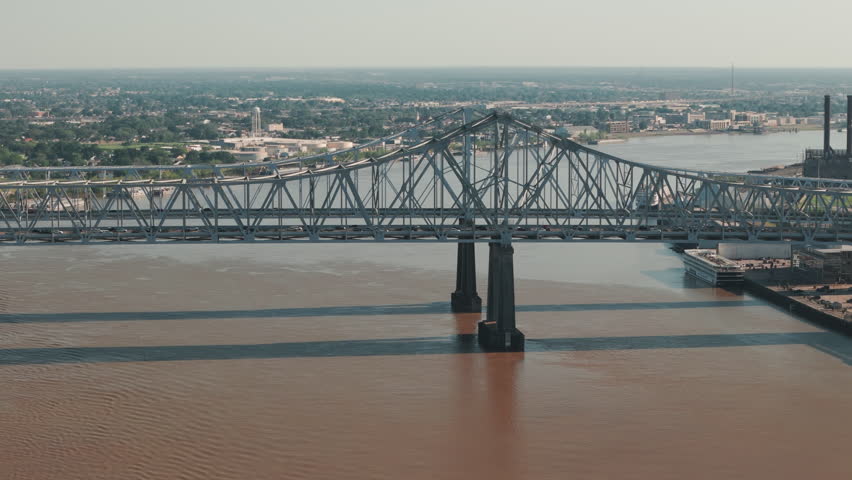 Drone shot of bridge over Mississippi River waterfront and downtown city skyline New Orleans, Louisiana