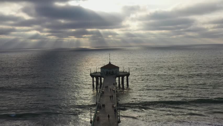 Sunset View Of Roundhouse Aquarium At Manhattan Beach Pier In California, USA. aerial pullback