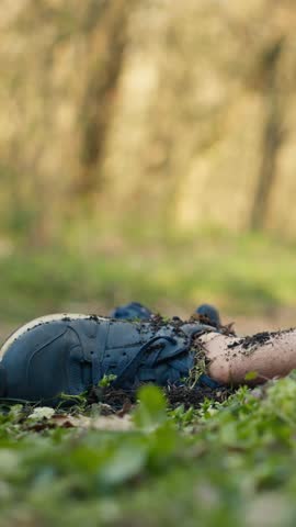 Rescuers group finding murdered barefoot victim in the forest, scared people calling the police. Mysterious horror manslaughter in the woods, civilians found a dead body, grim murder. Camera A.