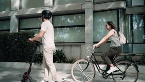 Video of cheerful woman riding a bicycle crosses a concentrated man on an electric scooter through the city - Powered by Shutterstock - Get 15% off with code: PIKWIZARD15