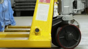 Worker pulls and drags pallet truck out from wooden crates in factory, zoom out low angle static - Powered by Shutterstock - Get 15% off with code: PIKWIZARD15