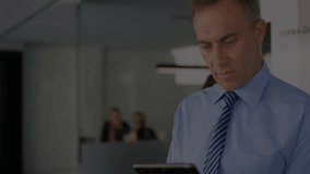 Animation of financial data processing over caucasian businessman using tablet. Global finance, business, connections, computing and data processing concept digitally generated video. - Powered by Shutterstock - Get 15% off with code: PIKWIZARD15