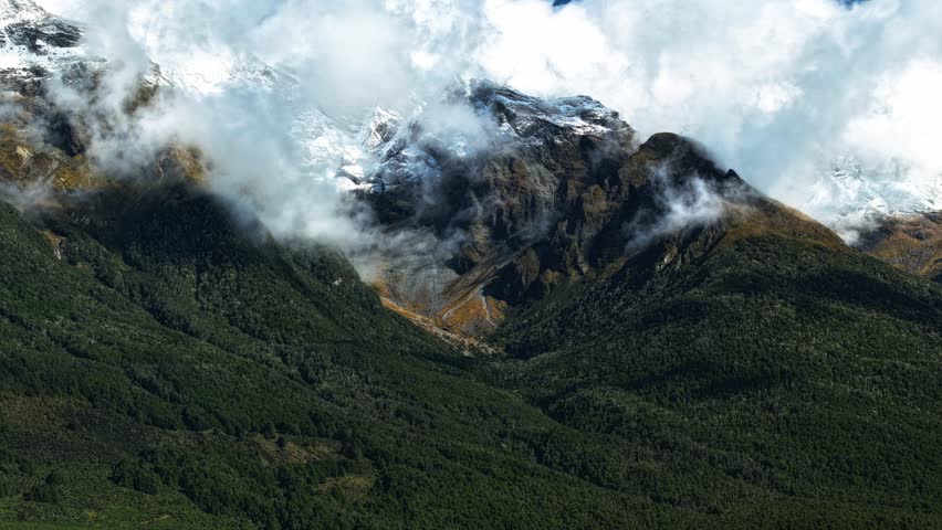 Beech forests of Glenorchy breathe clouds up into air wispy shadows on mountains