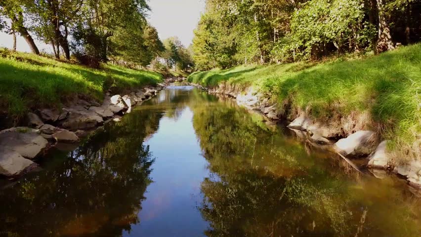 River with stones and trees byside cinematic droneshot Austria