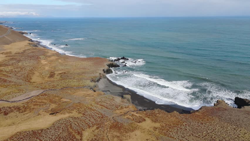 Panoramic beach Icelandic landscape with a road through sand dunes aerial ocean
