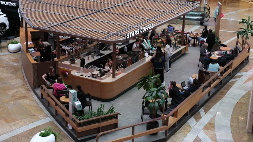 People are sitting at tables in a cafe. Russia Moscow April 23, 2024