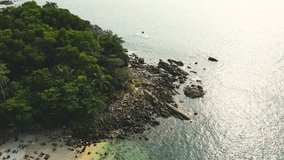 Freedom beach, Patong Phuket, Thailand - Tropical island with white paradise sand beach and turquoise clear water and granite stones. Drone high angle video.
