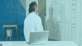 Animation of financial data processing over diverse doctors discussing work in hospital. Global medicine, healthcare, computing and digital interface concept digitally generated video. - Powered by Shutterstock - Get 15% off with code: PIKWIZARD15