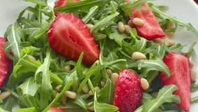 Vitamin salad of strawberry with arugula. Vegan food. Summer salad.