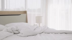 Footage Handheld medium shot, Asian elderly woman was cleaning the dusty bed in bedroom, She use hand closed her nose during arranges pillows and white duvet - Powered by Shutterstock - Get 15% off with code: PIKWIZARD15