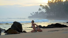 Slim woman in bikini performs leg pigeon pose amidst rolling waves at sunset. Lady with braids relishes yoga workout by ocean - Powered by Shutterstock - Get 15% off with code: PIKWIZARD15