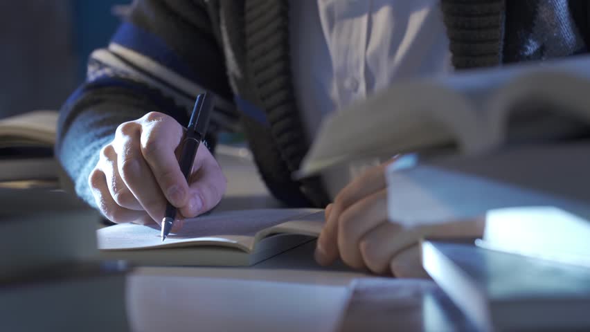 Close-up male hands reading a book. A man reading a book is researching, collecting information.