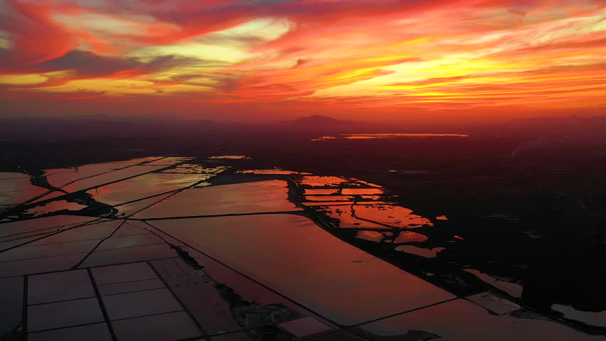 Spectacular aerial view at sunset in the Santapola Salt Flats, over the sea water lagoons, with the city of Santapola in sight, Spain.
