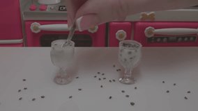 Macro video of making chia seed pudding in a miniature, toy kitchen.