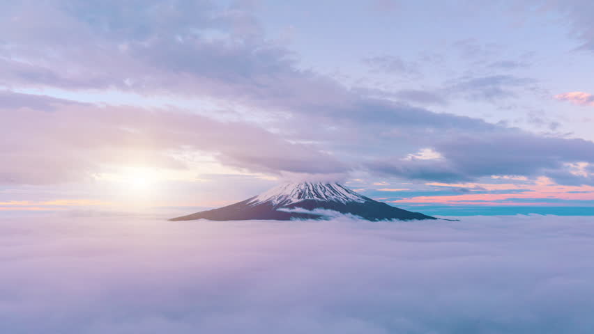 Aerial view of Mount Fuji with beautiful clouds over a clear sky and morning mist at sunrise. Japan