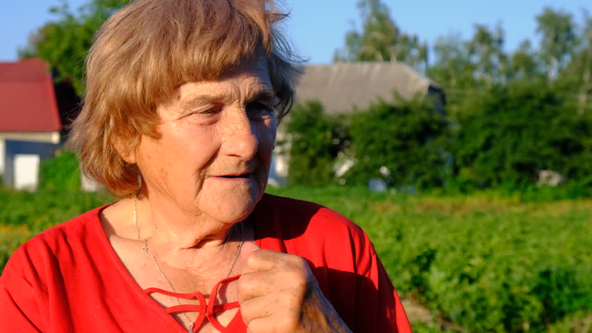 portrait of a grandmother in the garden. Selective focus.