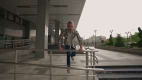 Young Adult Man in a Shirt Effectively Overcomes Obstacles on the Way Using Acrobatic Stunts and Parkour. Success and Achievement. Youth Culture and People Concept. Slow Motion - Powered by Shutterstock - Get 15% off with code: PIKWIZARD15