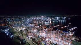 Night aerial view of gantry cranes, cargo ships and containers at cargo terminal of large international sea port - Powered by Shutterstock - Get 15% off with code: PIKWIZARD15