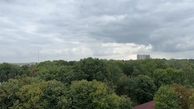 filming a video from a Ferris wheel in the city of Vinnitsa, Ukraine old attractions view of the city Tall iron wheel in the park colorful baskets green trees. rainy sky