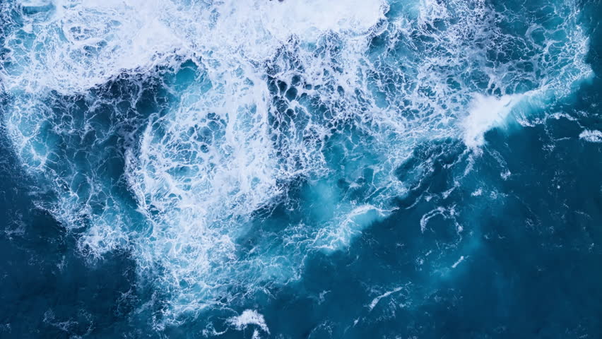 Big power ocean waves with white foam. Aerial top view footage of fabulous sea tide on a stormy day