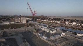 Evening falls over a new Dutch neighborhood with dozens of homes under construction to address severe housing shortage.