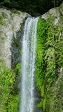Beautiful splash of water from the waterfalls. Katibawasan Falls. Camiguin Island. Philippines. Vertical video.