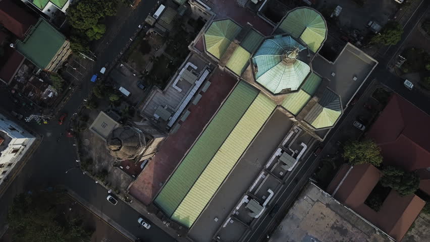Aerial Tilt Up Shot Of The Manila Cathedral In Residential City Against Cloudy Sky