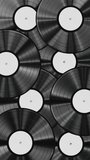Vertical video. Realistic looping 3D animation of the classic black vinyl records with white labels rendered in UHD as motion background.