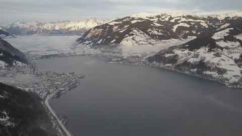 Aerial view of the Alps. The resort village of Zell am See near the lake. Peaks of mountains in the snow in winter. Ski resort in Austria. Leisure. Winter sports