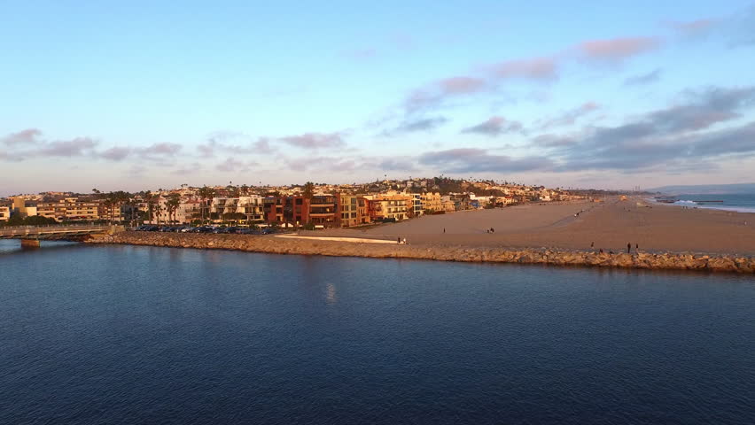 Aerial Scenic View Of Residential Buildings In City, Drone Flying Forward Over Rippled Sea Under Cloudy Sky - Marina Del Rey, California