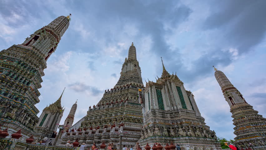 Time lapse of the great pagodas richly decorated at Wat Arun. pagoda is Thai architecture applied in Chinese style. Decorated with glazed tiles and Multicolor wares. Wat Arun landmark in Bangkok. 
