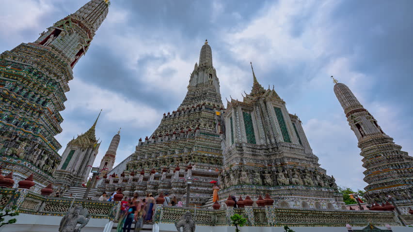 Time lapse of the great pagodas richly decorated at Wat Arun. pagoda is Thai architecture applied in Chinese style. Decorated with glazed tiles and Multicolor wares. Wat Arun landmark in Bangkok. 
