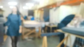 Unfocused background video of workers assembling upholstered furniture in a factory. It can be used as a background for the main page of the site.