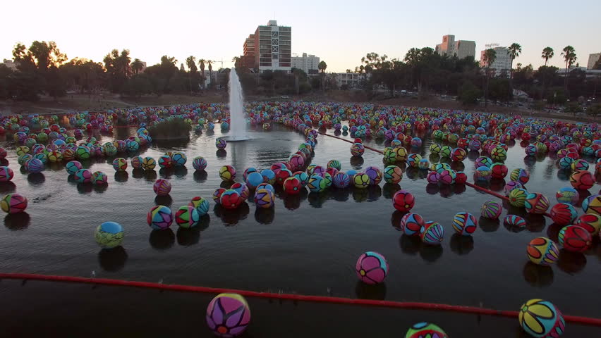 Aerial Forward Ascending Shot Of Colorful Balls At Famous Macarthur Park In Residential City During Sunset - Los Angeles, California