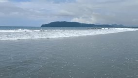 Video recording of Holtekamp Beach, Jayapura, Papua, showing the beach and mountains behind it