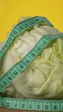 The Cabbage and the measurement tape are spinning. Sports nutrition, fitness and diet concept. Rotating Closeup vertical footage