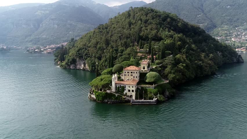 Aerial bird view arriving at Villa del Balbianello is a mansion in the comune of Lenno province of Como and is famous for its elaborate terraced gardens at this moment a popular visit for tourists 4k