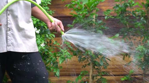 Watering garden slow motion.grass and turf making,gardening environment,turf surface on the ground,grass in garden design,football field making.