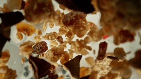Super Slow Motion of Falling Cereals into Milk. Camera Follows the Target, Overhead Shot. Filmed on High Speed Cinema Camera, 1000fps, Placed on Cine Bot. - Powered by Shutterstock - Get 15% off with code: PIKWIZARD15
