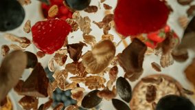 Super Slow Motion of Falling Cereals into Milk. Camera Follows the Target, Overhead Shot. Filmed on High Speed Cinema Camera, 1000fps, Placed on Cine Bot. - Powered by Shutterstock - Get 15% off with code: PIKWIZARD15