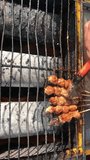 Cilok bakar video, Indonesian street food. Cilok on the grill. Roasted cilok at on the grill. Cilok are usually tapioca balls skewered and served in peanut sauce. Grilled meatball in rural area. Tasty
