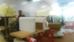 Unfocused background video of workers assembling upholstered furniture in a factory. It can be used as a background for the main page of the site.