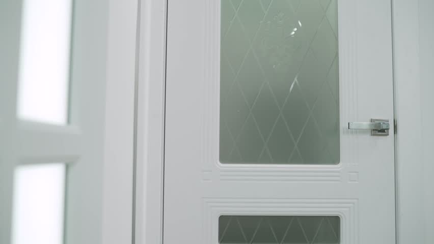 Beautiful white door in the interior of a door sales salon. Door salon. White interior door.