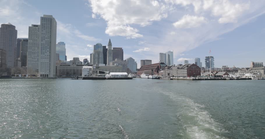 Boston Harbor view of the cities downtown scape from a ferry on a sunny day in 4k.