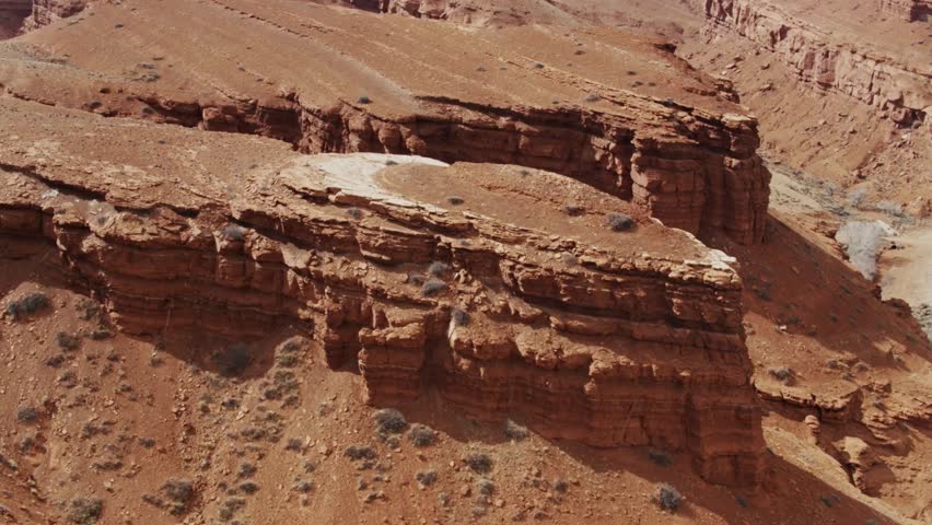 Craggy Wyoming Landscape with Snowy Mountains in Distance - Drone Shot
