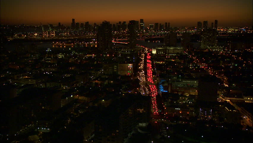 Aerial Illuminated sunset view of South Beach luxury Art Deco hotels and Condominiums MacArthur vehicle Causeway Miami Cityscape Florida USA